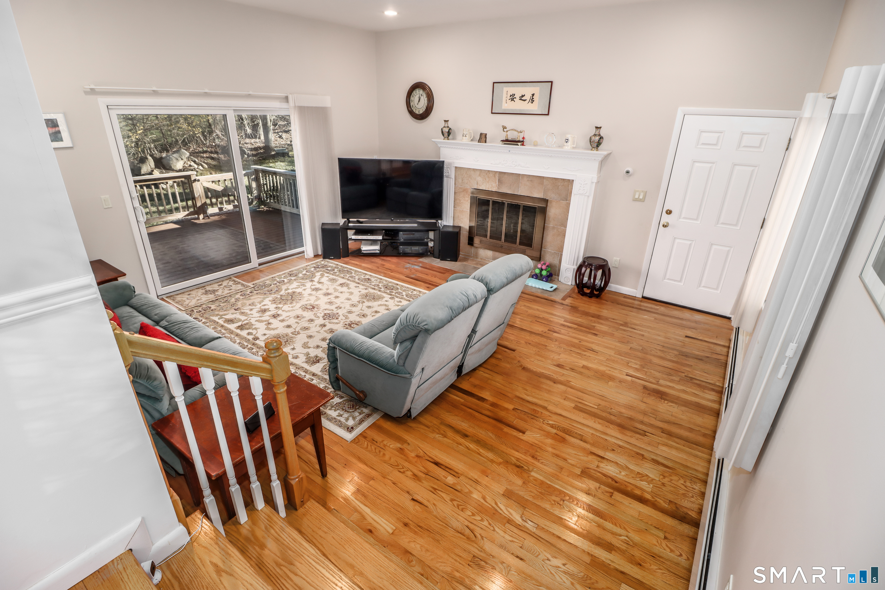 35 East Gate Road Danbury, CT 06811 - Photo 11 of 37 a living room with furniture a flat screen tv and a fireplace