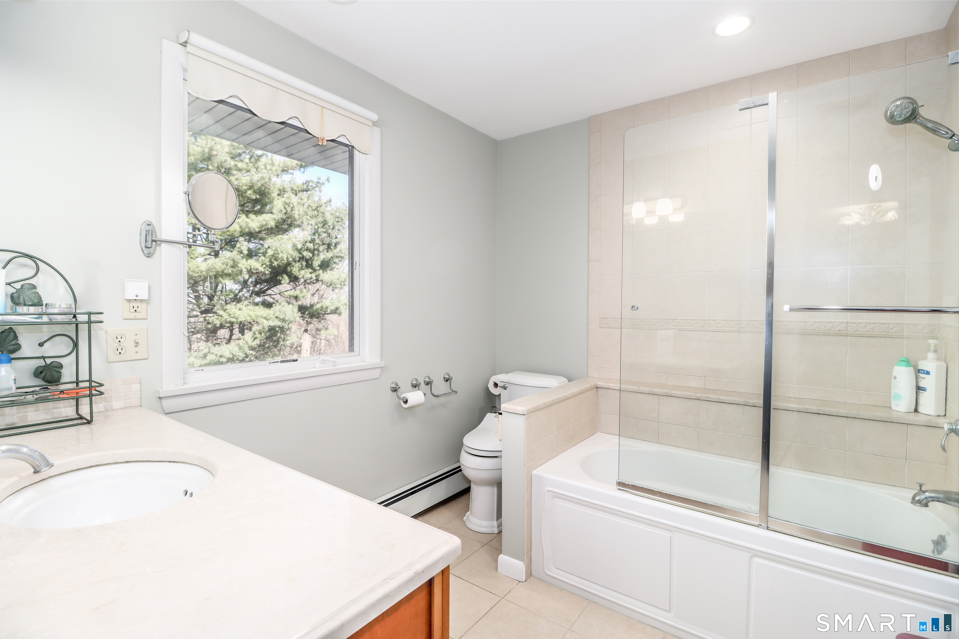 35 East Gate Road Danbury, CT 06811 - Photo 18 of 37 a bathroom with a tub a sink and a large window