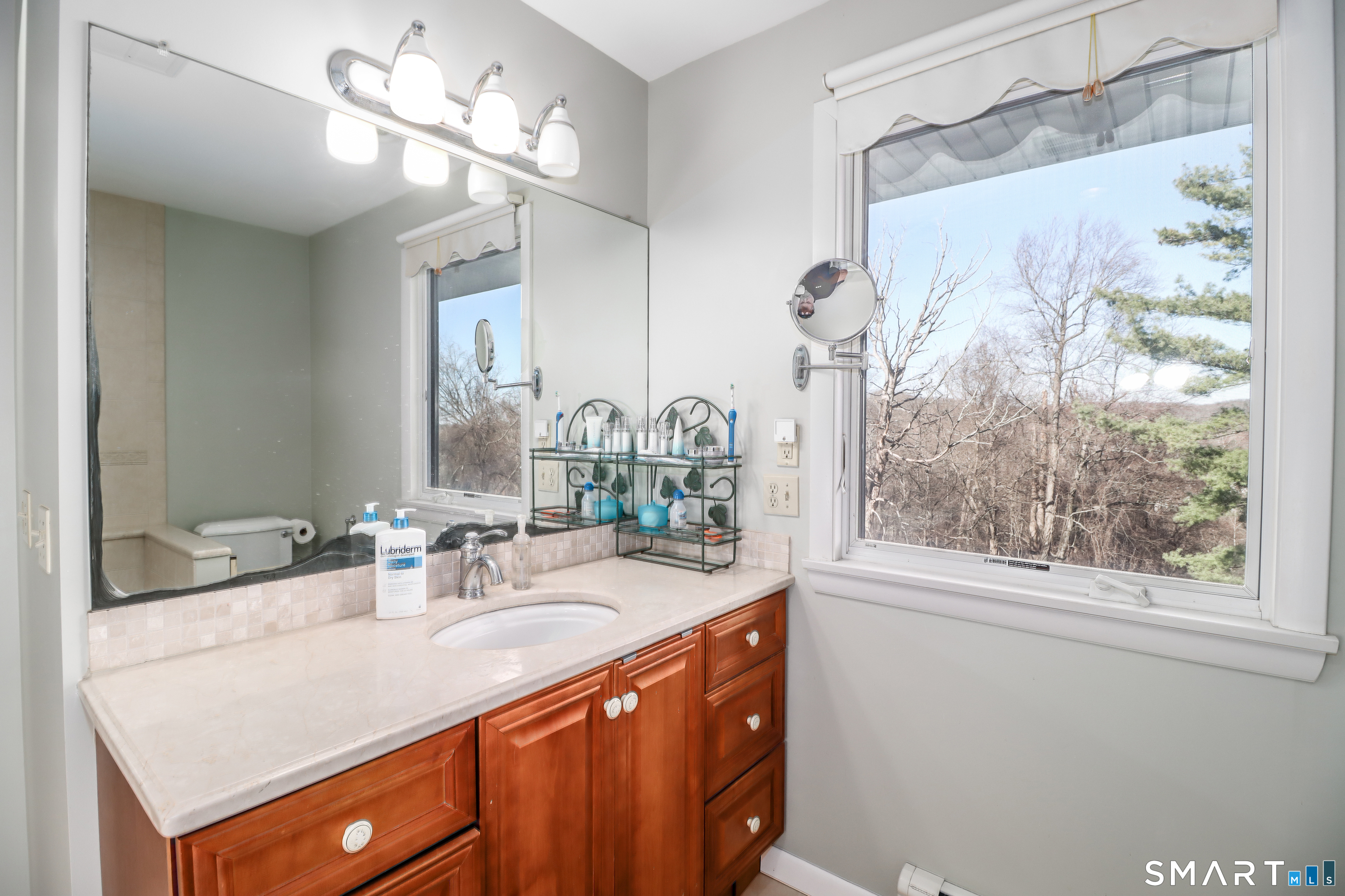 35 East Gate Road Danbury, CT 06811 - Photo 19 of 37 a bathroom with a sink a large mirror and a window