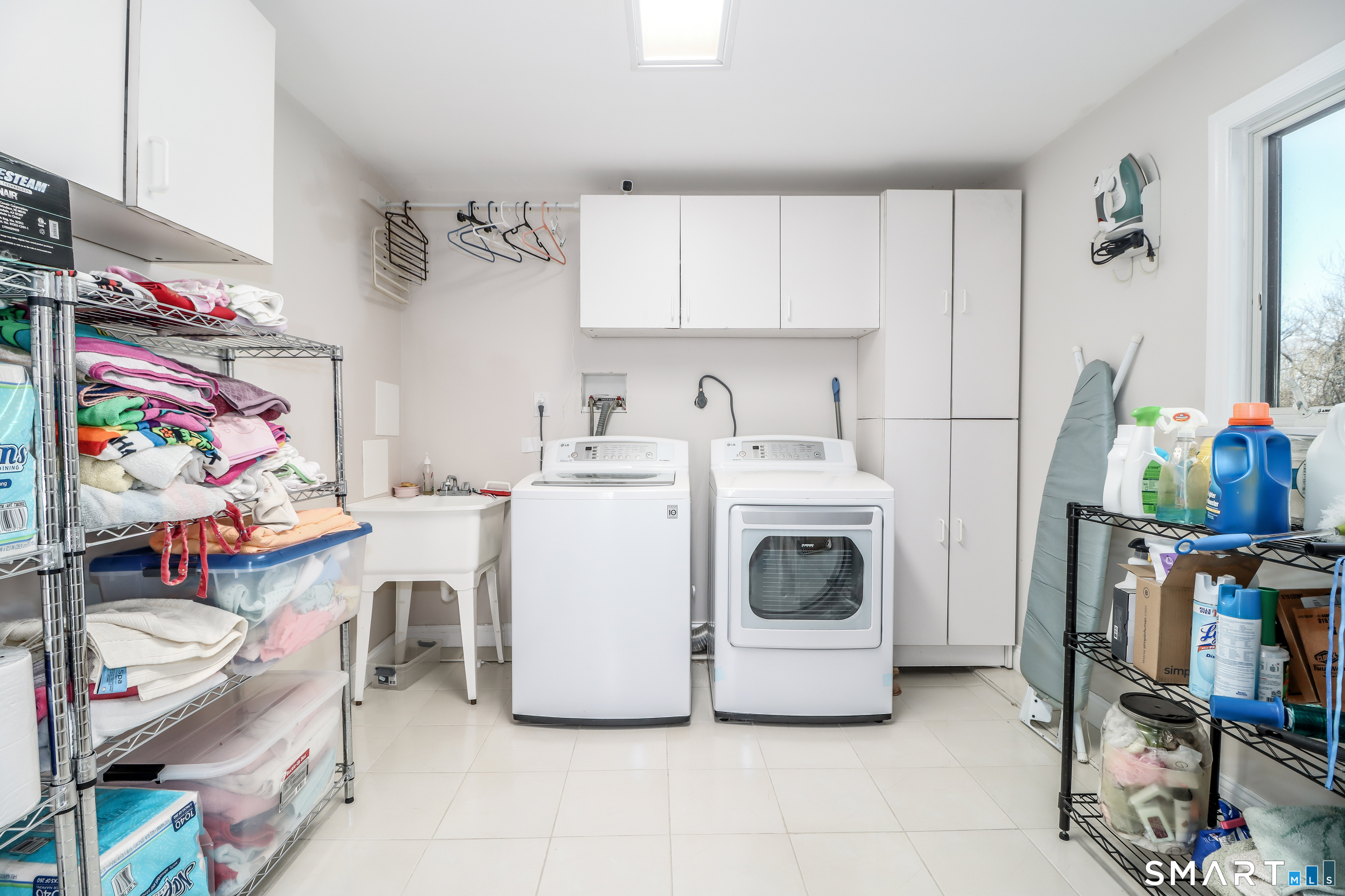 35 East Gate Road Danbury, CT 06811 - Photo 32 of 37 a utility room with cabinets dryer and washer