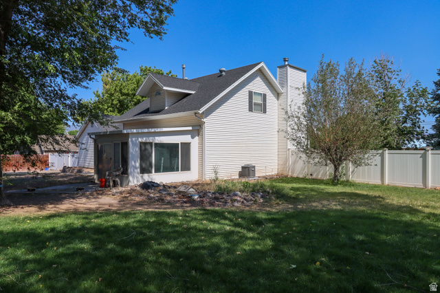 270 East 100 North Monroe, UT 84754 - Photo 39 of 65 Expansive backyard featuring a manicured lawn, established tree, and a white privacy fence