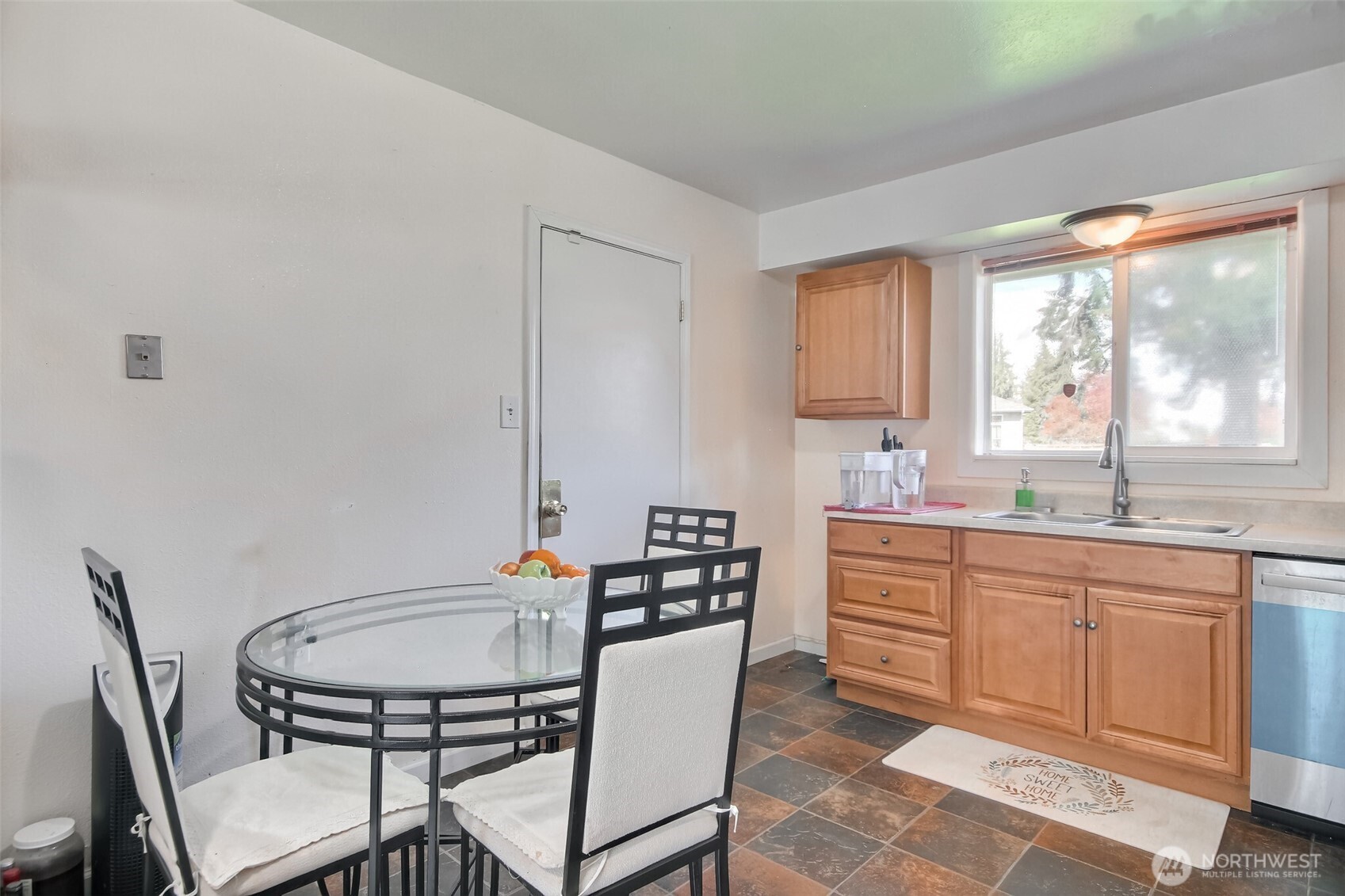 810 Southwest 356th Street Federal Way, WA 98023 - Photo 13 of 40 a kitchen with stainless steel appliances granite countertop a stove a sink a dining table and chairs
