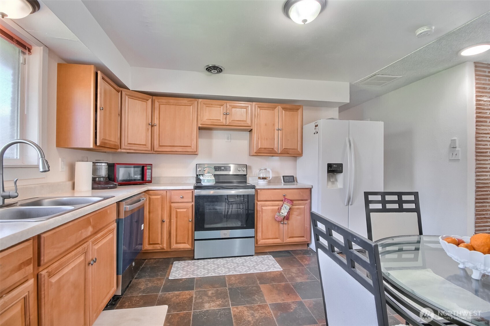 810 Southwest 356th Street Federal Way, WA 98023 - Photo 16 of 40 a kitchen with stainless steel appliances granite countertop a sink stove refrigerator and cabinets
