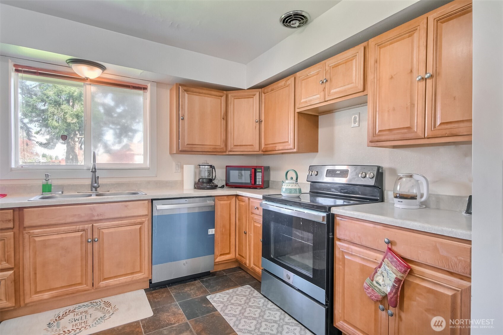 810 Southwest 356th Street Federal Way, WA 98023 - Photo 18 of 40 a kitchen with stainless steel appliances granite countertop a sink stove and cabinets