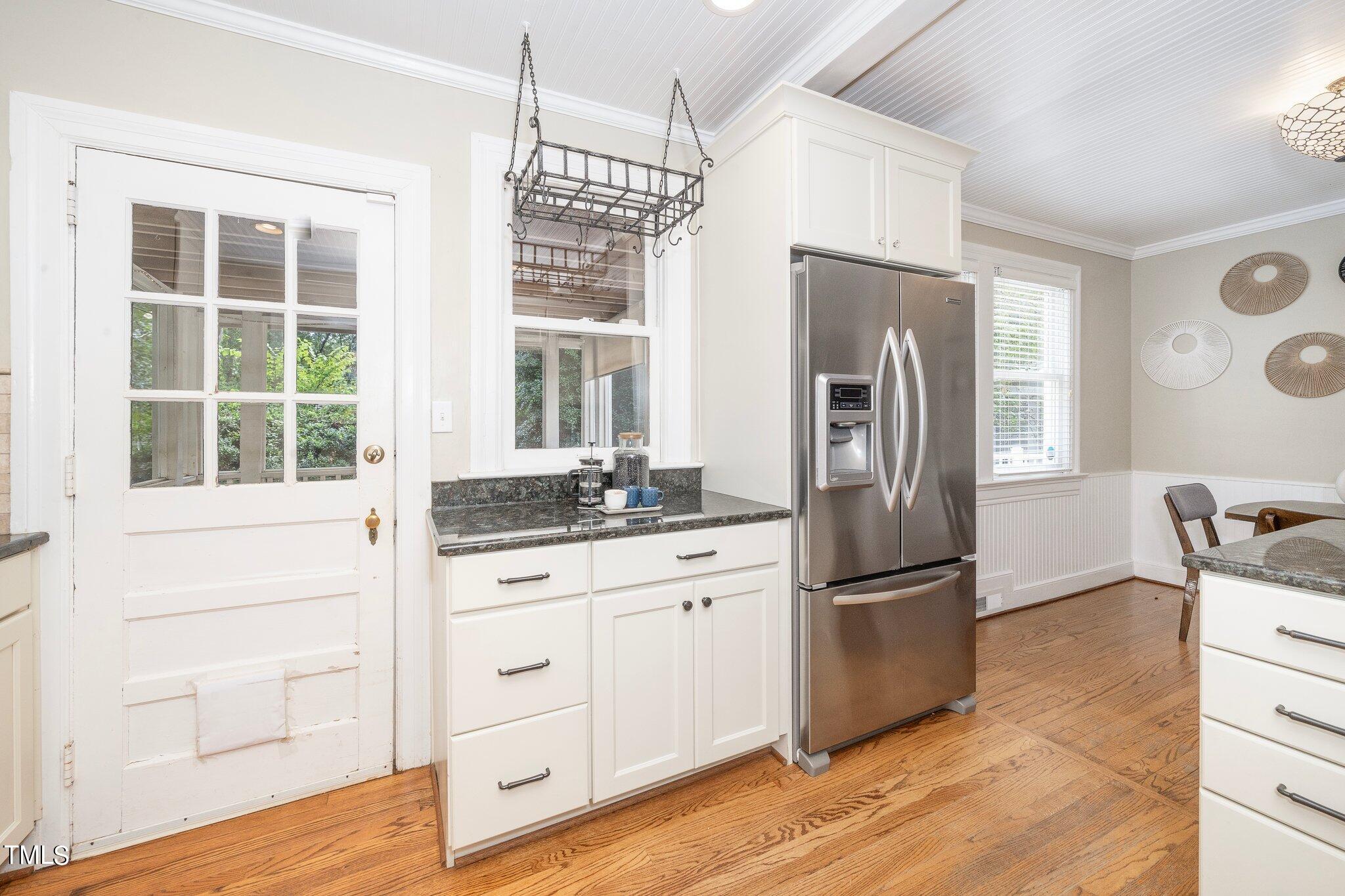 406 Brooks Avenue Raleigh, NC 27607 - Photo 11 of 33 a kitchen with stainless steel appliances granite countertop a refrigerator a stove and a sink with wooden floor