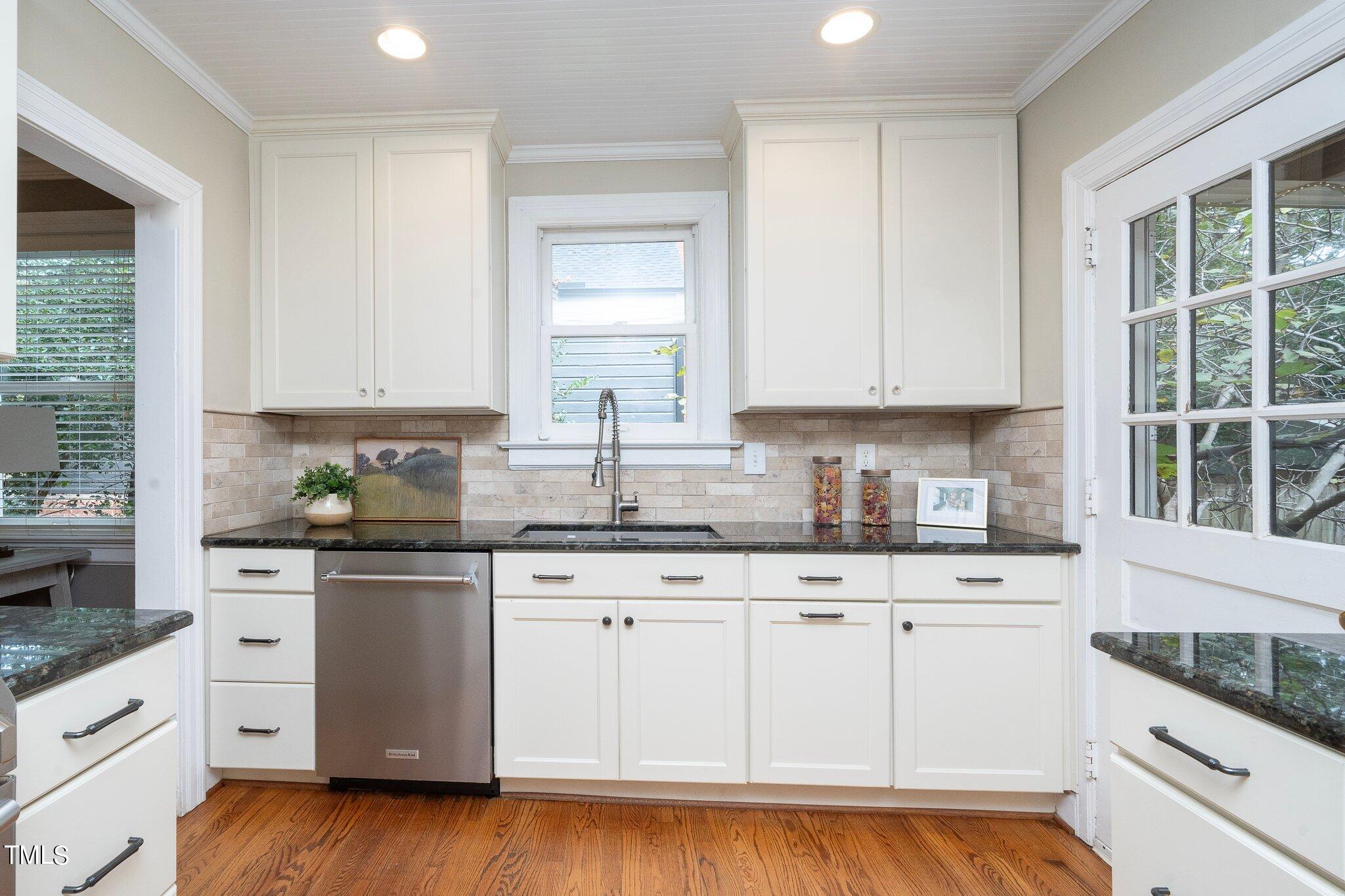 406 Brooks Avenue Raleigh, NC 27607 - Photo 13 of 33 a kitchen with granite countertop white cabinets and white appliances