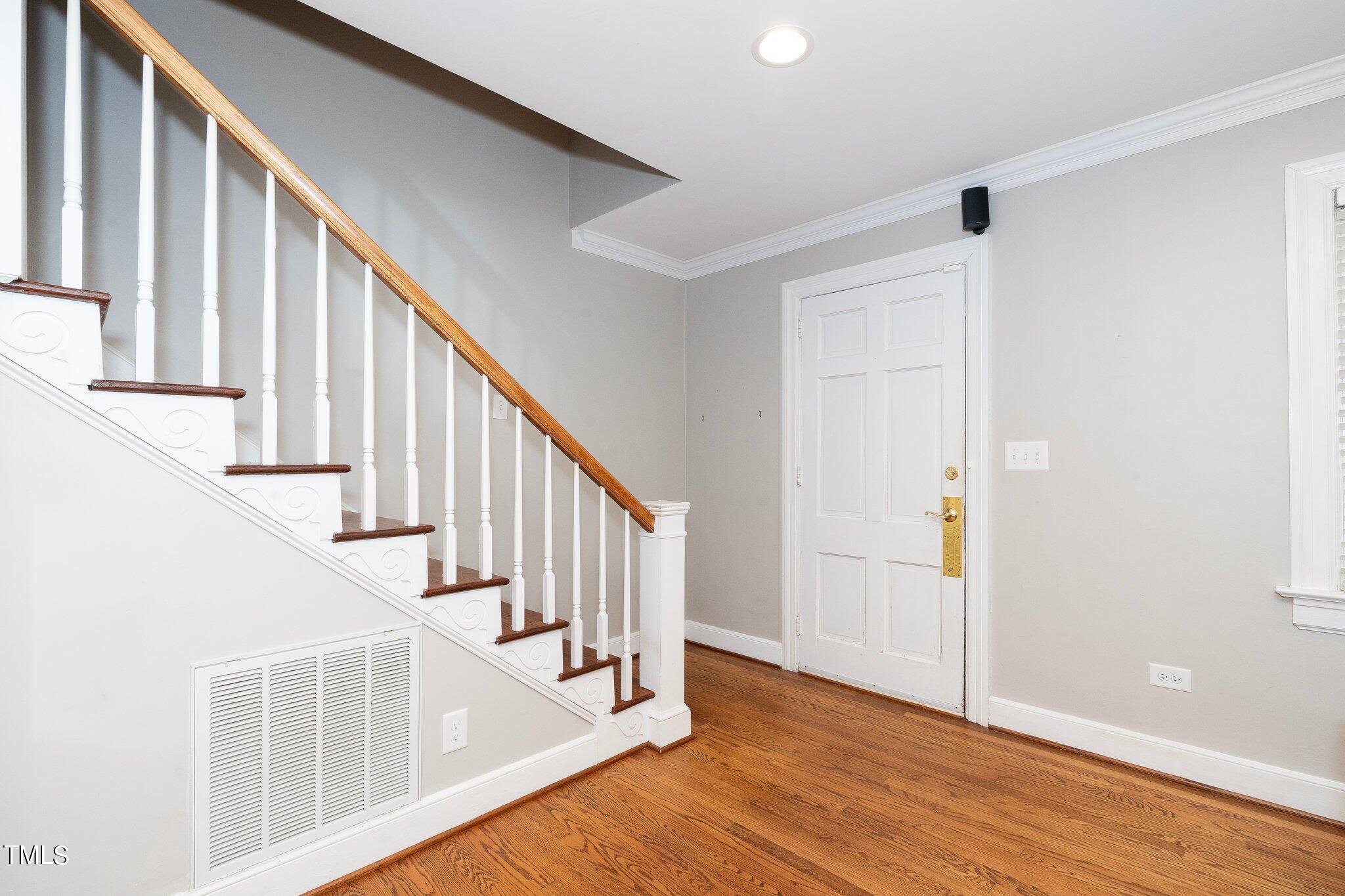 406 Brooks Avenue Raleigh, NC 27607 - Photo 24 of 33 a view of staircase with wooden floor and white walls