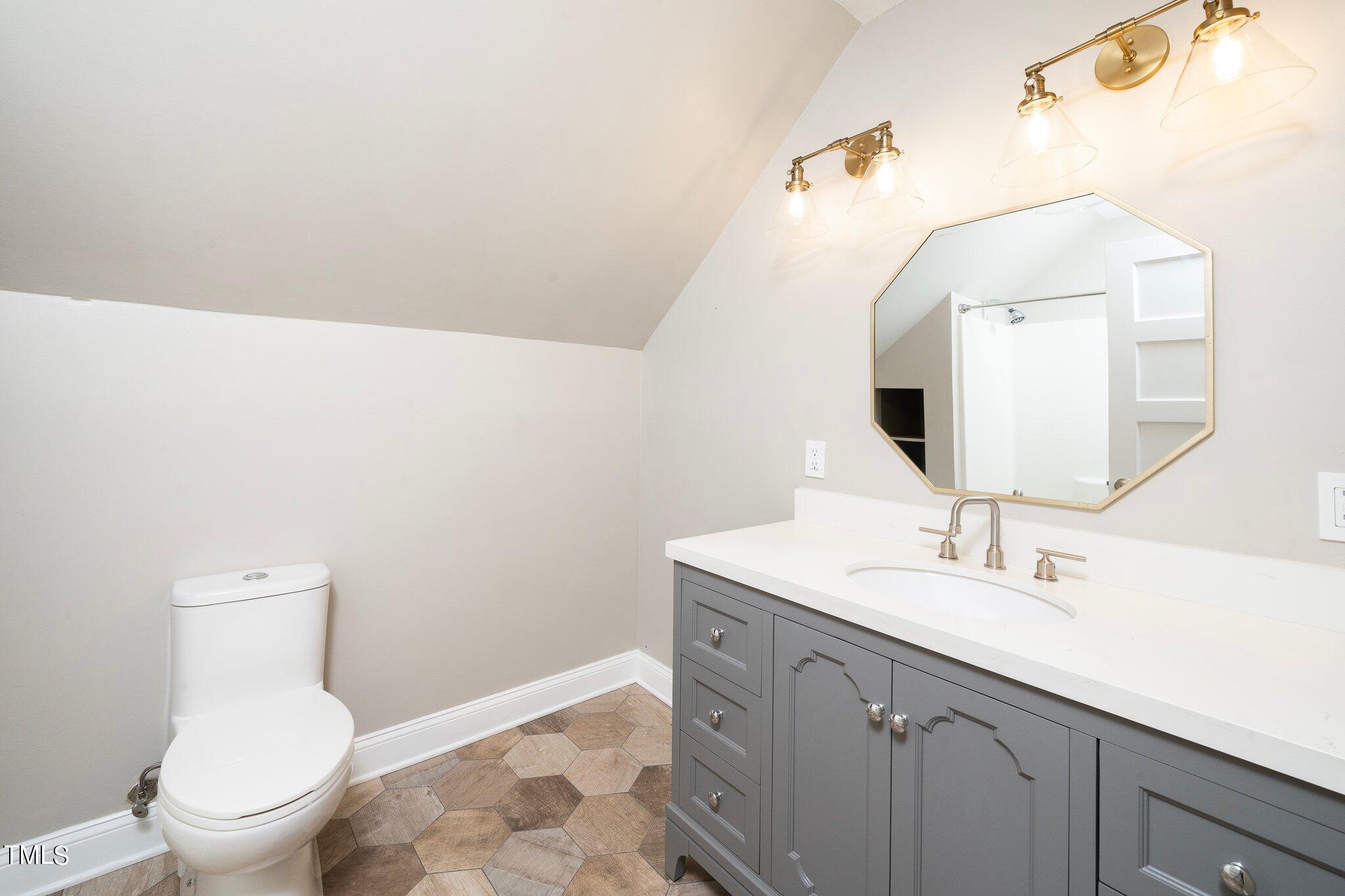 406 Brooks Avenue Raleigh, NC 27607 - Photo 26 of 33 a bathroom with a toilet sink and mirror