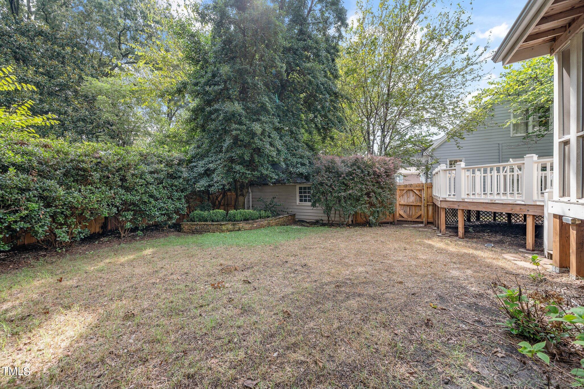 406 Brooks Avenue Raleigh, NC 27607 - Photo 30 of 33 a view of backyard with deck and trees