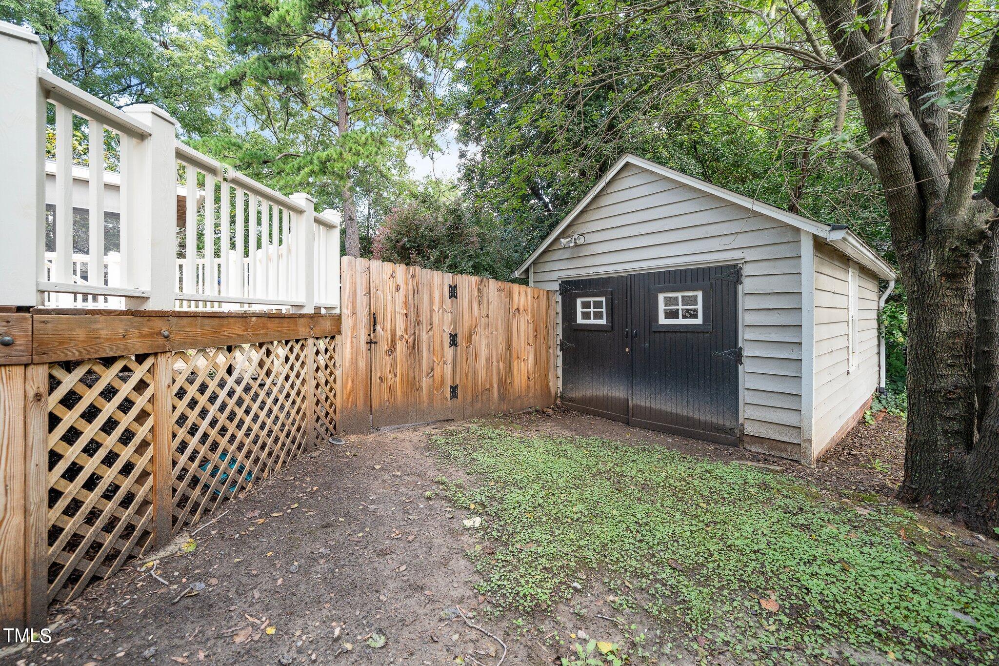 406 Brooks Avenue Raleigh, NC 27607 - Photo 32 of 33 a view of a house with a small yard and wooden fence