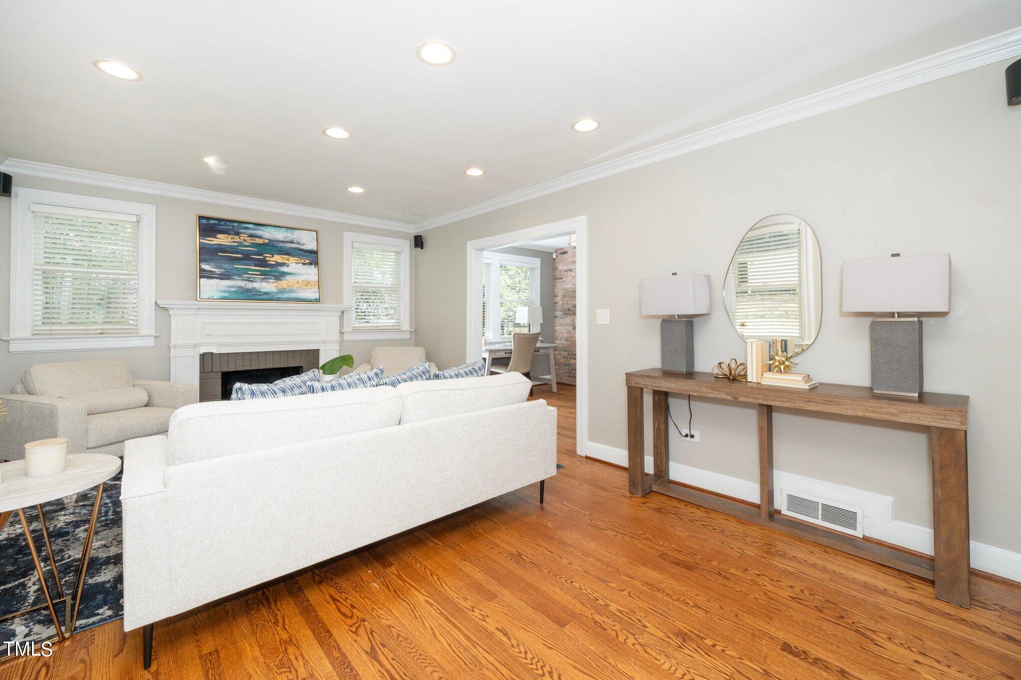 406 Brooks Avenue Raleigh, NC 27607 - Photo 5 of 33 a living room with furniture and a fireplace