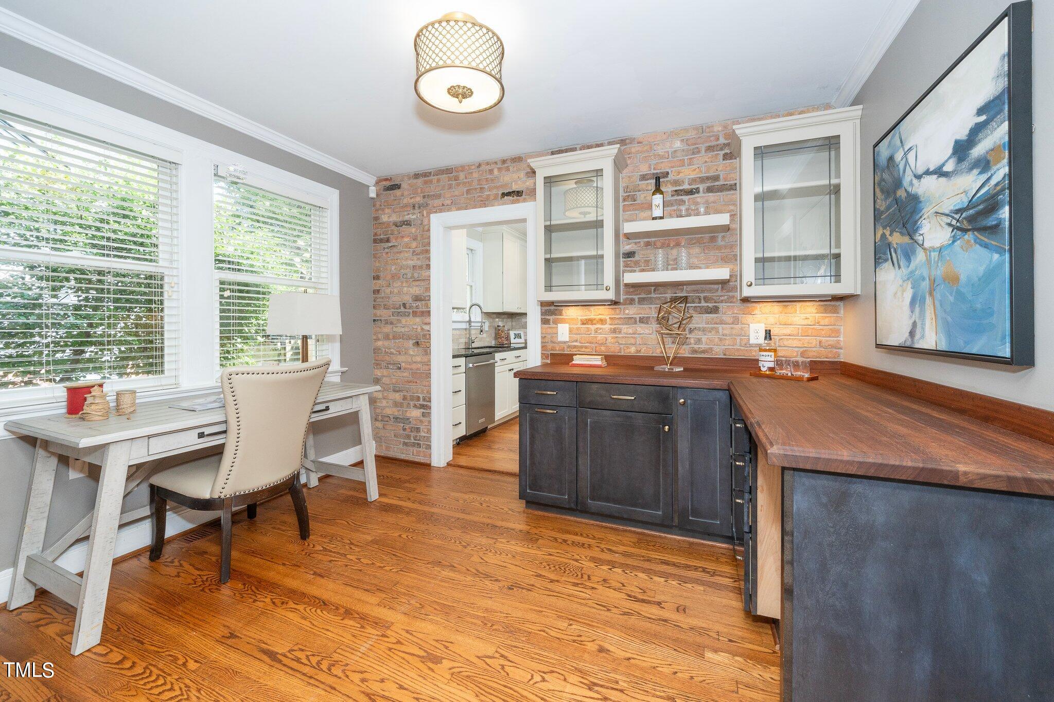 406 Brooks Avenue Raleigh, NC 27607 - Photo 8 of 33 a room with granite countertop a sink dishwasher a dining table and chairs with wooden floor