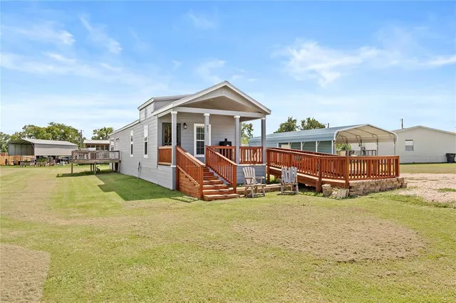 a view of a house with yard and sitting area