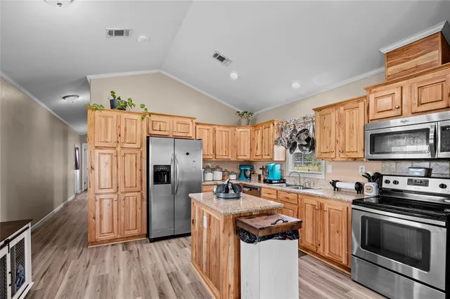 a kitchen with stainless steel appliances a refrigerator stove and sink