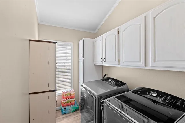 a kitchen with stainless steel appliances white cabinets and a stove top oven