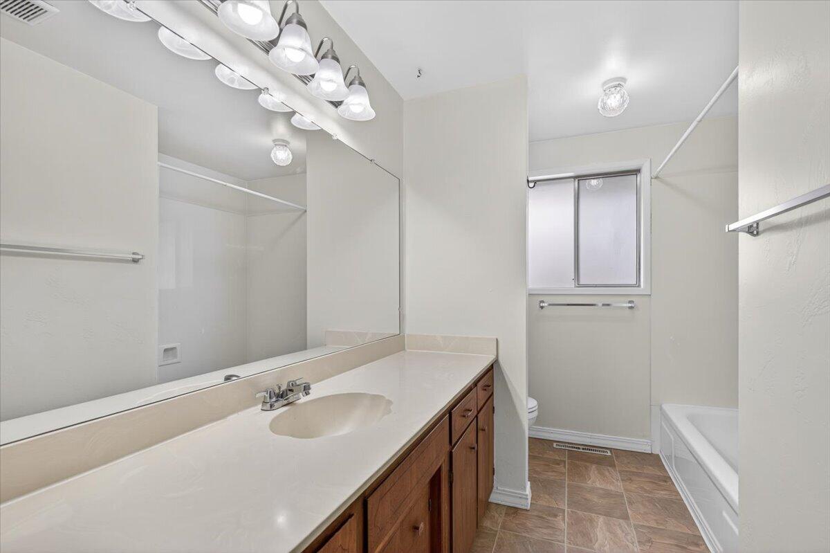 415 Sutter Avenue Medford, OR 97504 - Photo 23 of 28 a bathroom with a sink vanity granite and a mirror
