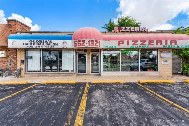 a view of a cafe with a table and chairs in front of it