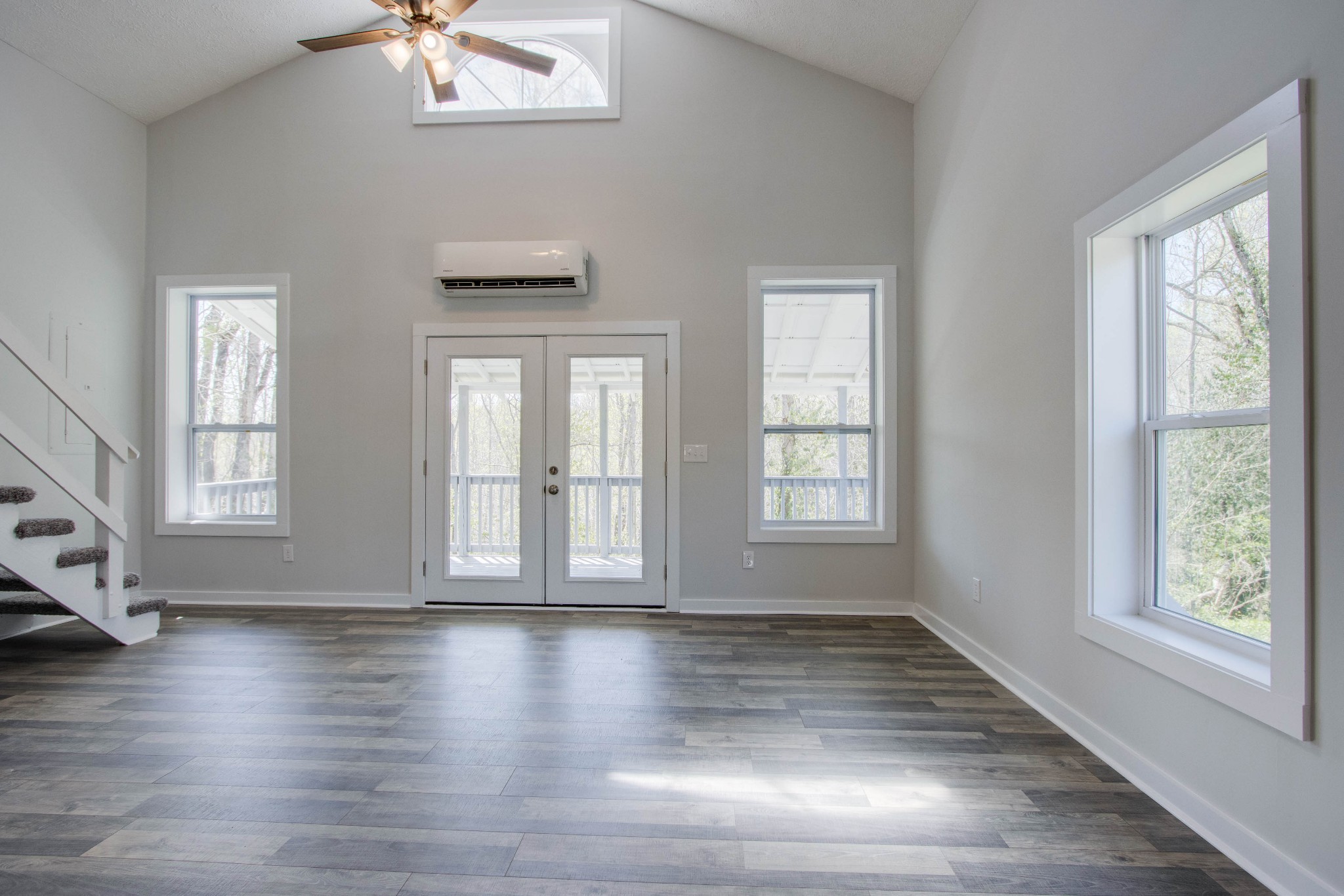 424 Austin Lake Road Baxter, TN 38544 - Photo 15 of 31 an empty room with wooden floor and windows