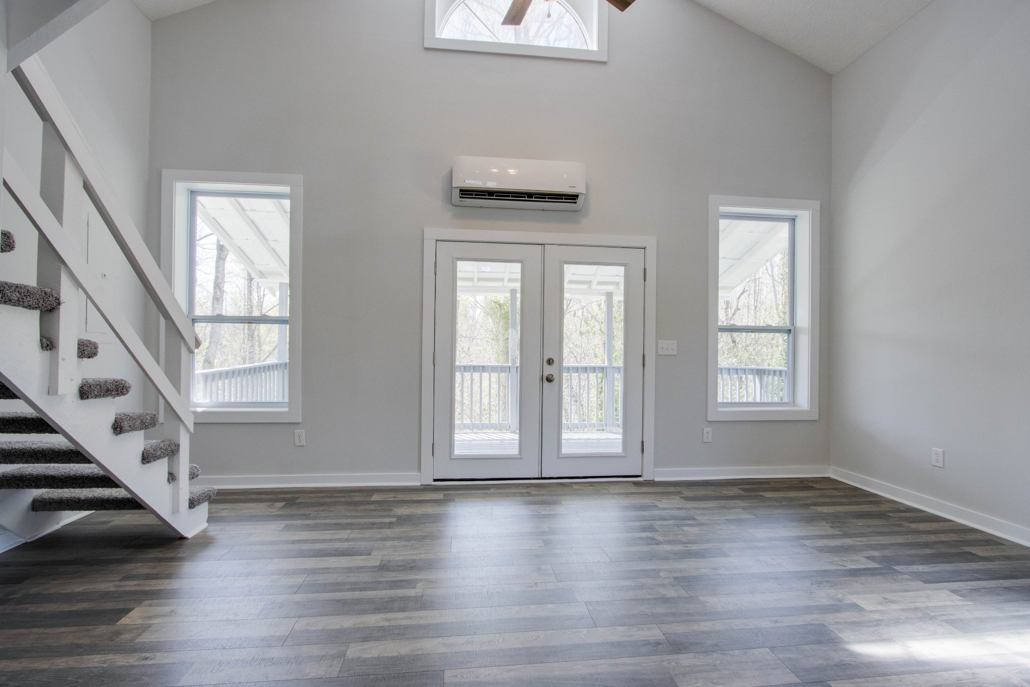 424 Austin Lake Road Baxter, TN 38544 - Photo 22 of 31 an empty room with wooden floor and windows