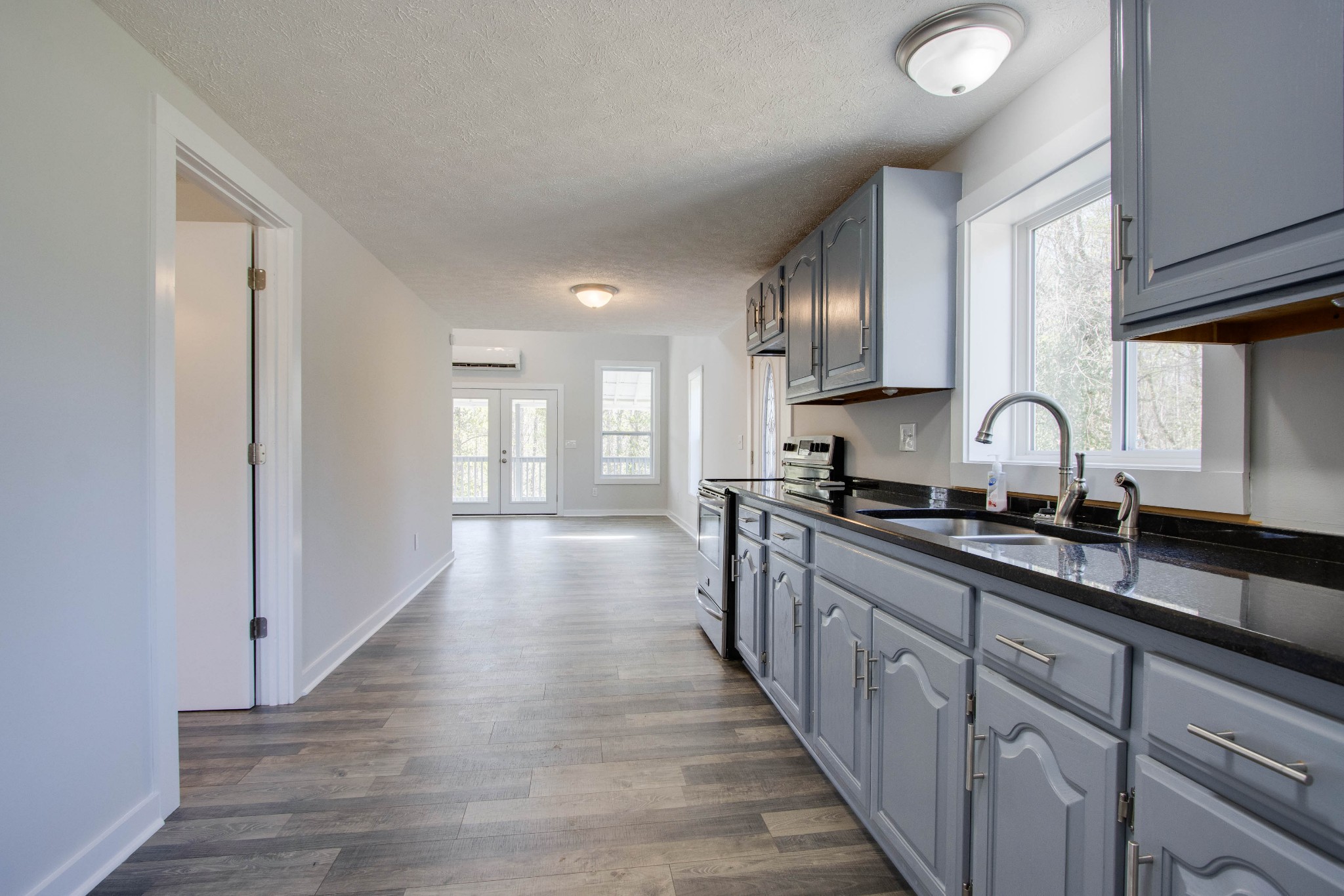 424 Austin Lake Road Baxter, TN 38544 - Photo 26 of 31 a large kitchen with granite countertop a large counter top space a sink stainless steel appliances and cabinets