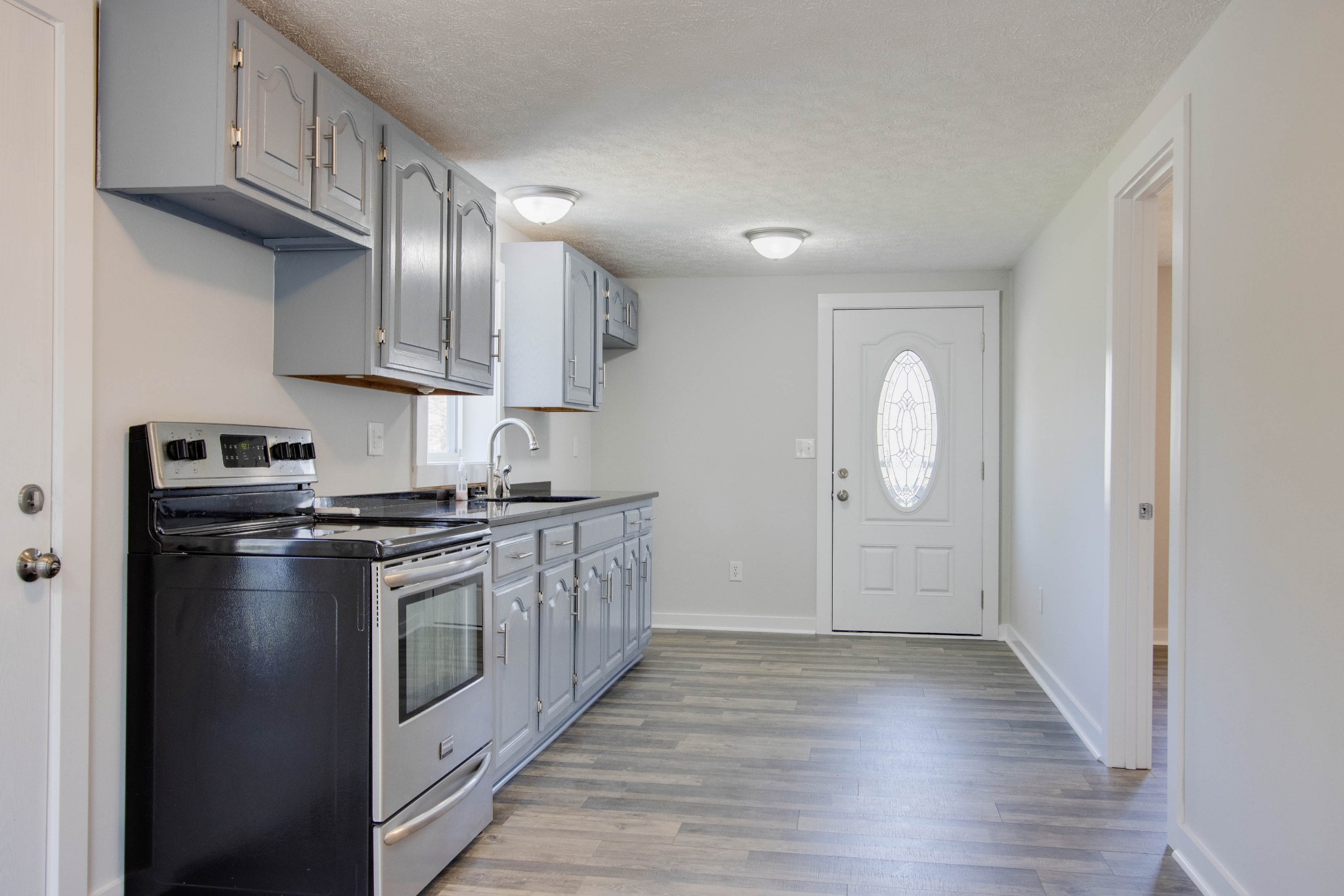424 Austin Lake Road Baxter, TN 38544 - Photo 27 of 31 a kitchen with stainless steel appliances granite countertop a stove a sink and a refrigerator