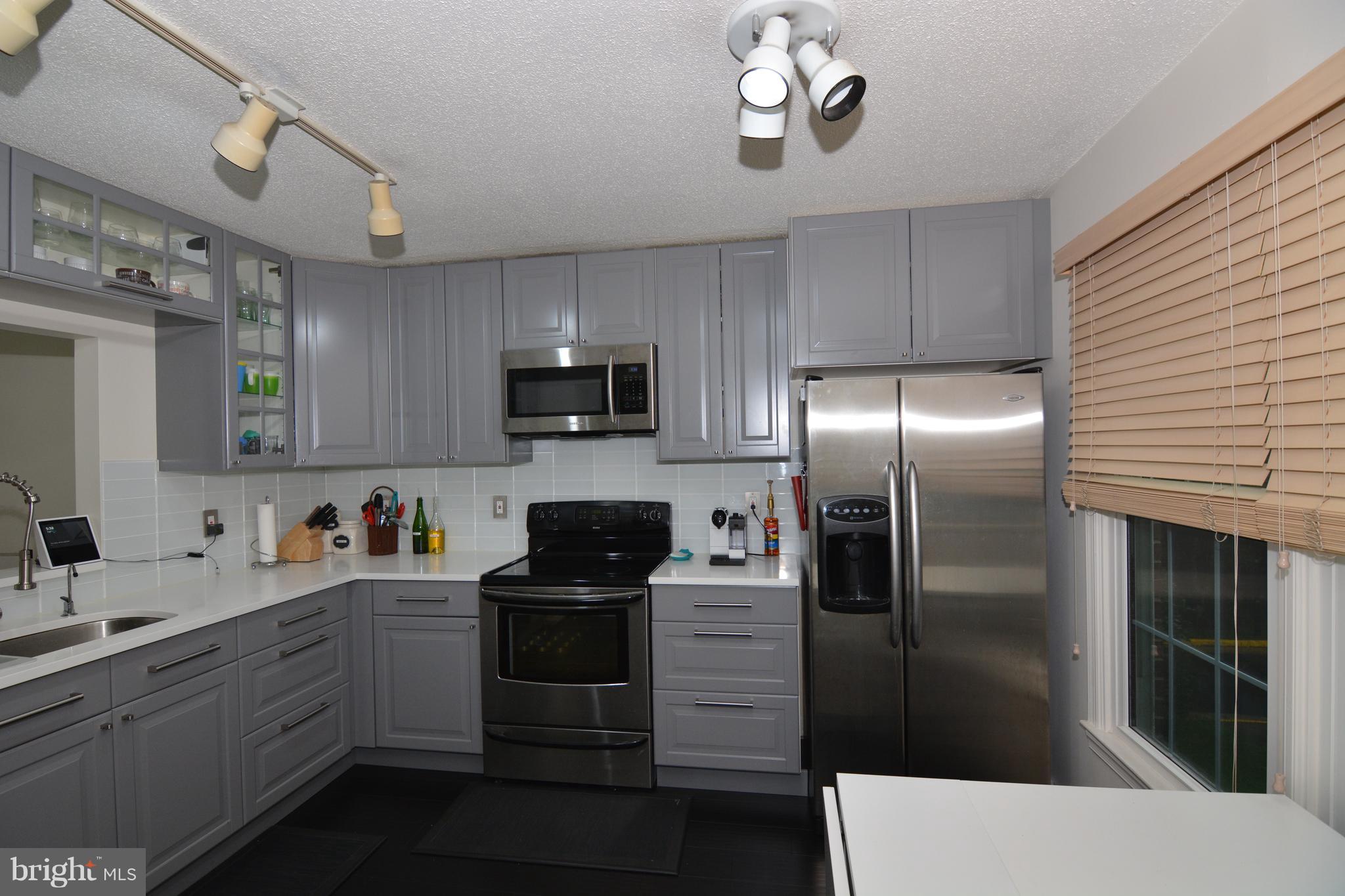 7211 Squirrel Run Court Springfield, VA 22152 - Photo 2 of 30 a kitchen with a sink stainless steel appliances and cabinets