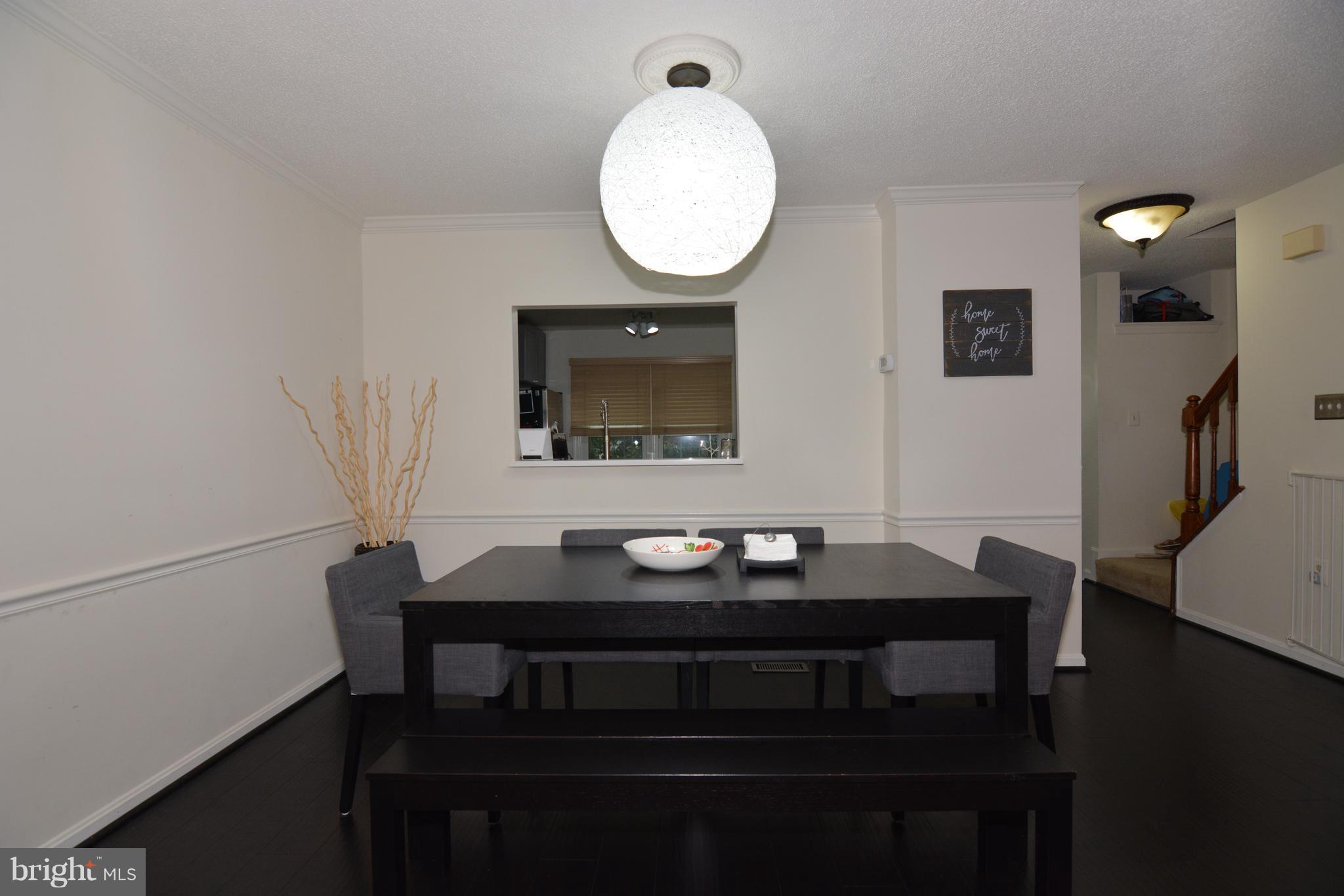 7211 Squirrel Run Court Springfield, VA 22152 - Photo 13 of 30 a view of a dining room with furniture and wooden floor