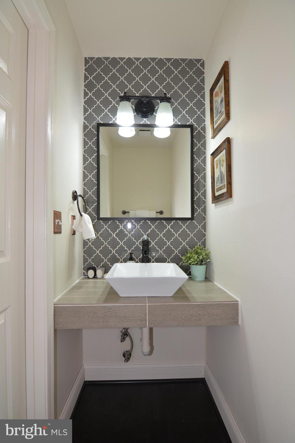 7211 Squirrel Run Court Springfield, VA 22152 - Photo 15 of 30 a bathroom with a sink and a mirror