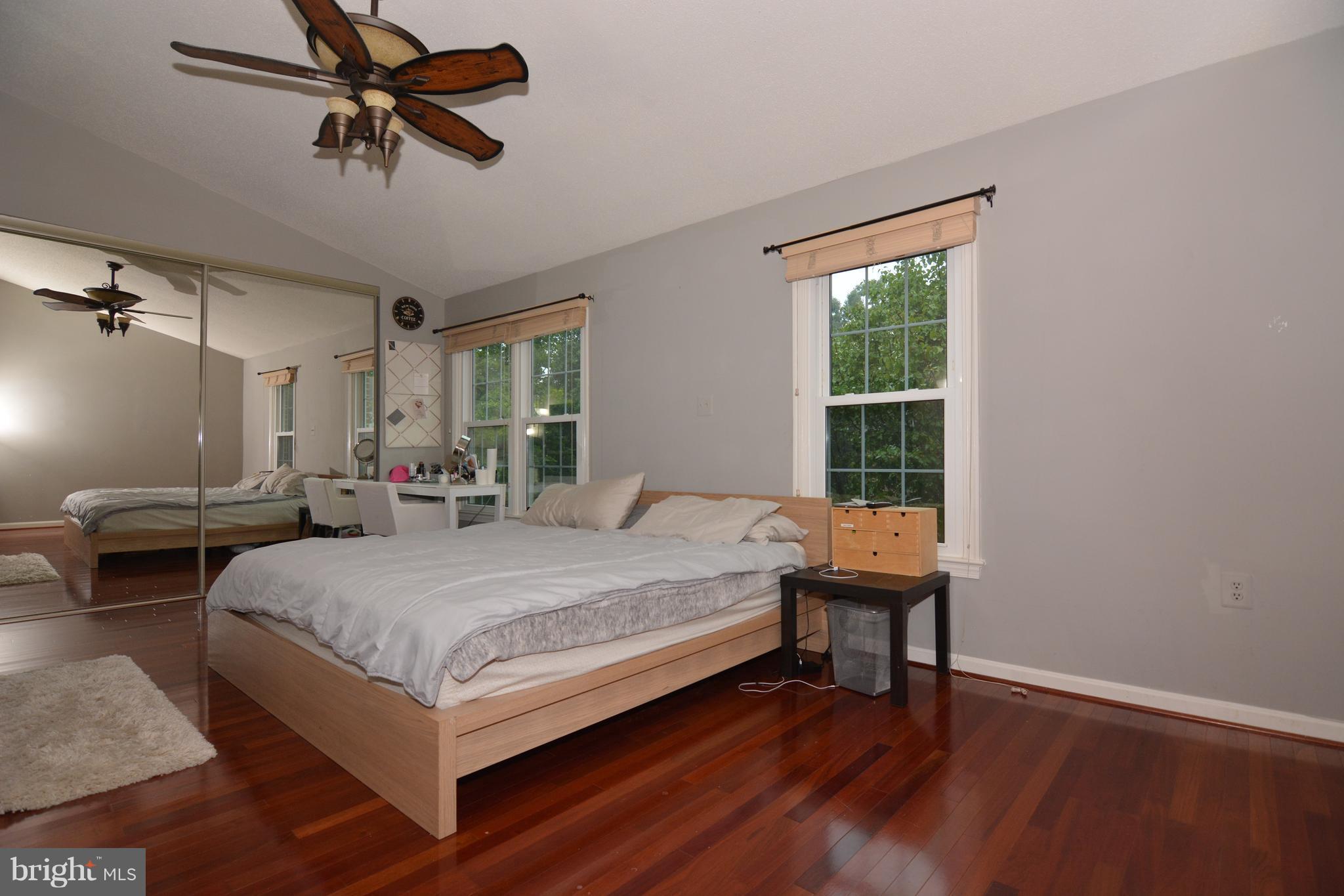 7211 Squirrel Run Court Springfield, VA 22152 - Photo 16 of 30 a bedroom with a bed a table and a window
