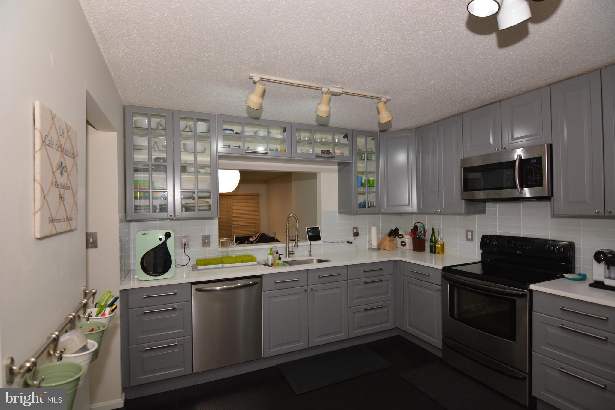 7211 Squirrel Run Court Springfield, VA 22152 - Photo 3 of 30 a kitchen with a sink window and cabinets