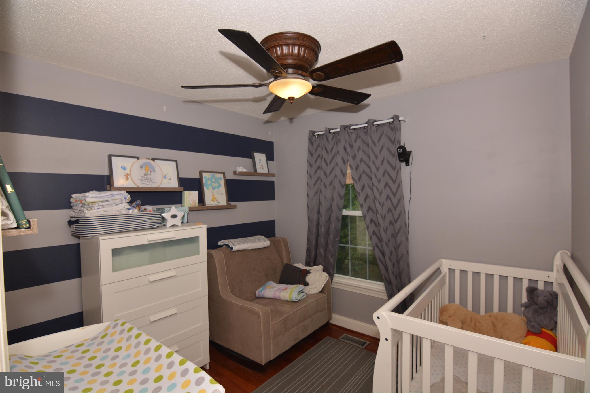 7211 Squirrel Run Court Springfield, VA 22152 - Photo 22 of 30 a bedroom with furniture and a window