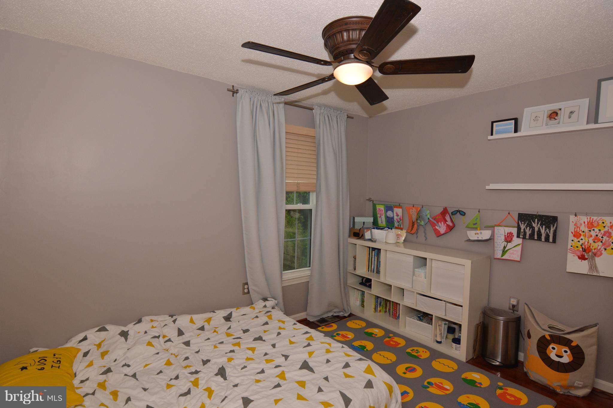 7211 Squirrel Run Court Springfield, VA 22152 - Photo 23 of 30 a bedroom with a bed and a chandelier