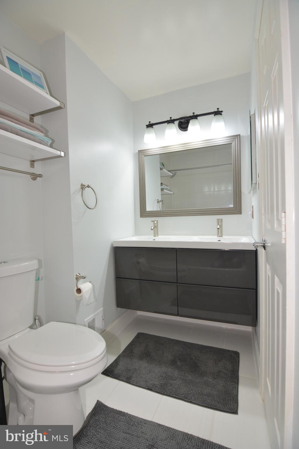 7211 Squirrel Run Court Springfield, VA 22152 - Photo 24 of 30 a bathroom with a sink and a mirror