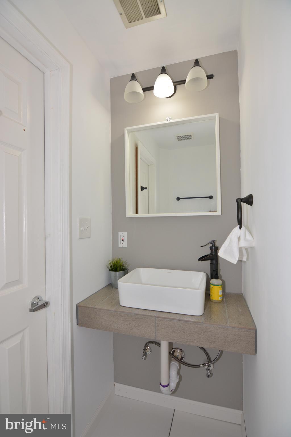 7211 Squirrel Run Court Springfield, VA 22152 - Photo 27 of 30 a bathroom with a sink and a mirror