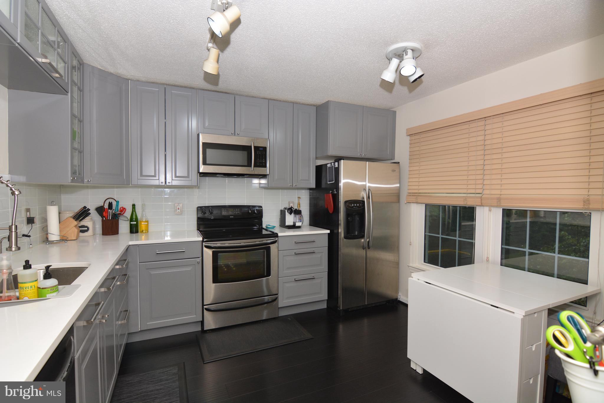 7211 Squirrel Run Court Springfield, VA 22152 - Photo 6 of 30 a kitchen with a refrigerator stove and microwave