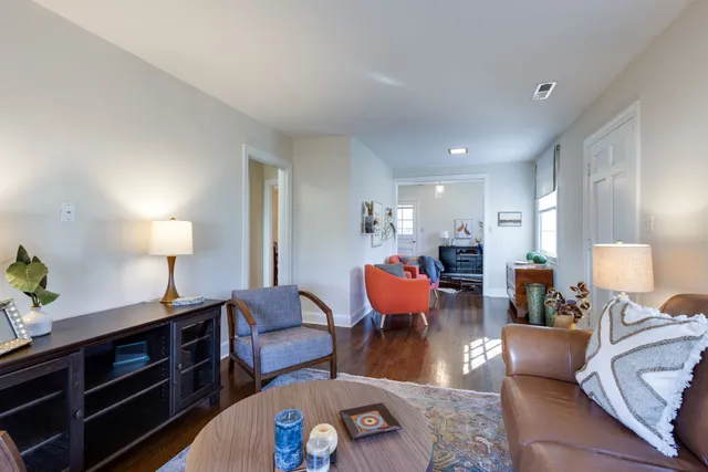a living room with furniture and a lamp