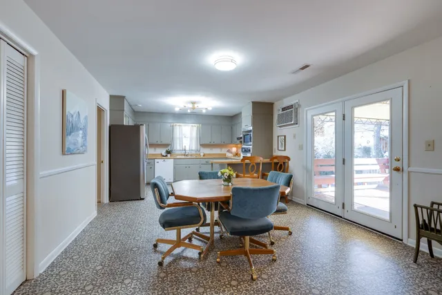 a dining room with furniture and a kitchen view