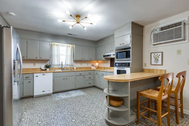 a kitchen with a white stove top oven and cabinets