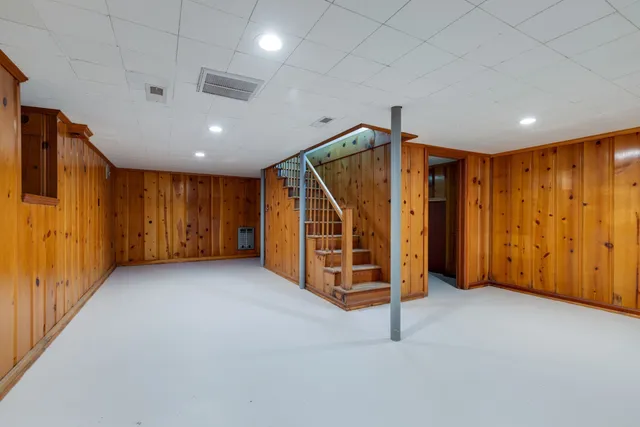 a view of an empty room with wooden walls