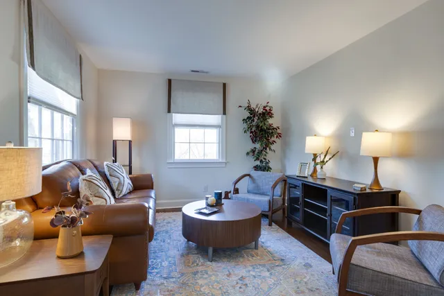 a living room with furniture and a lamp