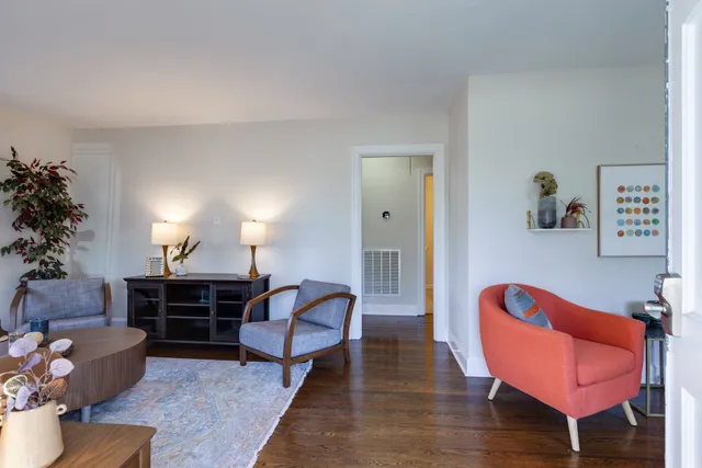 a living room with furniture a dining table chairs and a fireplace
