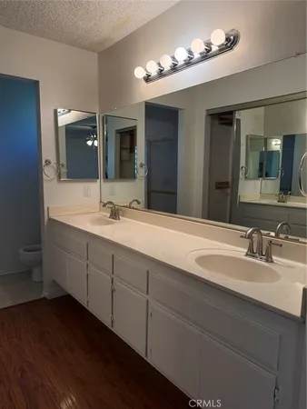 a bathroom with a double vanity sink and a mirror