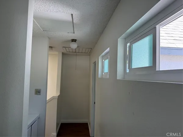 a view of hallway with window and chandelier