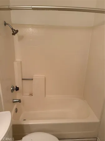 a bathroom with a bathtub and a toilet