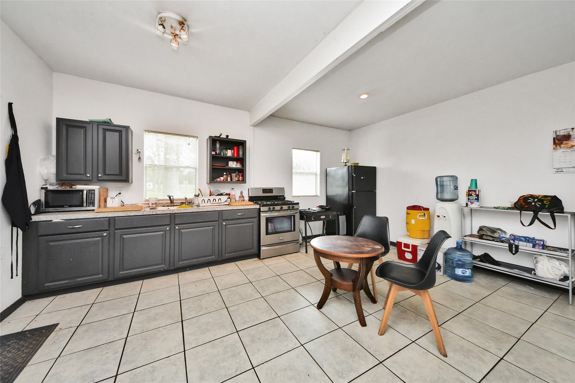 5310 Logston Lane Spring, TX 77389 - Photo 14 of 47 a kitchen with stainless steel appliances kitchen island granite countertop a sink and cabinets