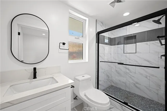 a view of a kitchen with a sink and dishwasher a stove top oven with wooden floor