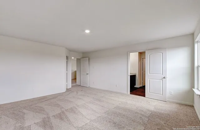 a view of an empty room and closet area