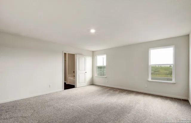 an empty room with a empty space and windows