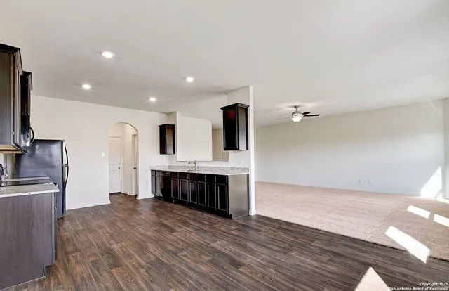 a view of kitchen with refrigerator microwave and stove