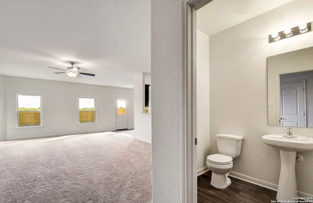a bathroom with a toilet sink and mirror